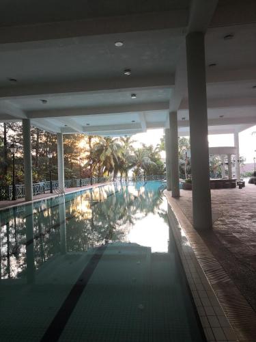 a swimming pool in a building with palm trees at 2R 1B Venice Hill Cheras Room1 & Room2 in Cheras
