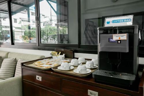 a coffee bar with a coffee box on a table at Annex Lumpini Bangkok in Bangkok