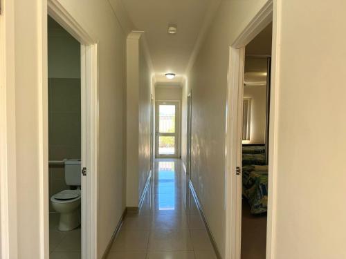 a hallway leading to a bathroom with a toilet at Oh Bouy, Unit 62 Seafront Estate in Jurien Bay