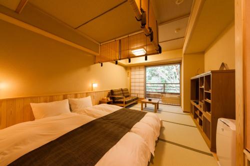 a bedroom with a large bed in a room at Ikyu in Ise