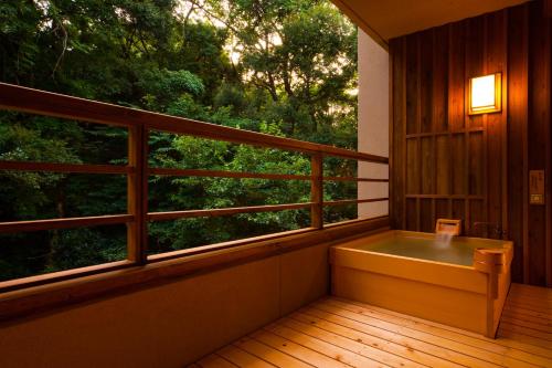 a balcony with a bench and a large window at Ikyu in Ise