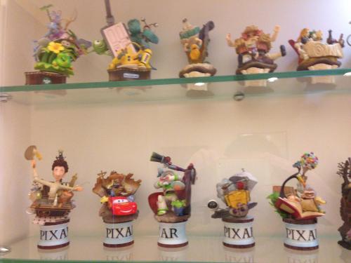 a shelf full of toy figurines on a wall at Doll House Lodge in Hengchun
