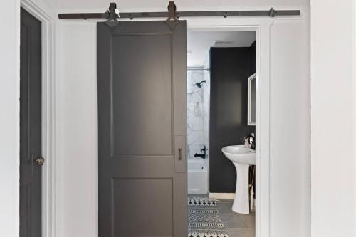 a bathroom with a white door and a sink at Cozy Beach Cottage Near The Bay in Villas