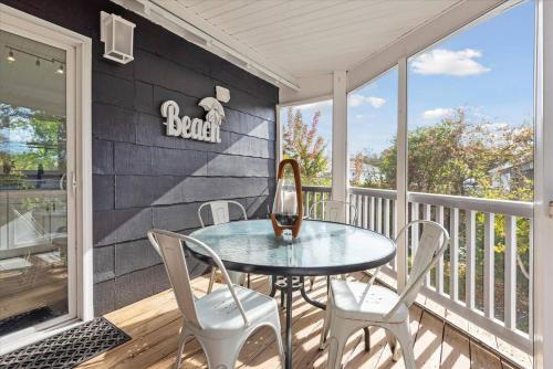 a patio with a table and chairs on a porch at Cozy Beach Cottage Near The Bay in Villas