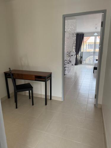 a room with a desk and a chair and a hallway at Thalassa Kata Beach in Kata Beach
