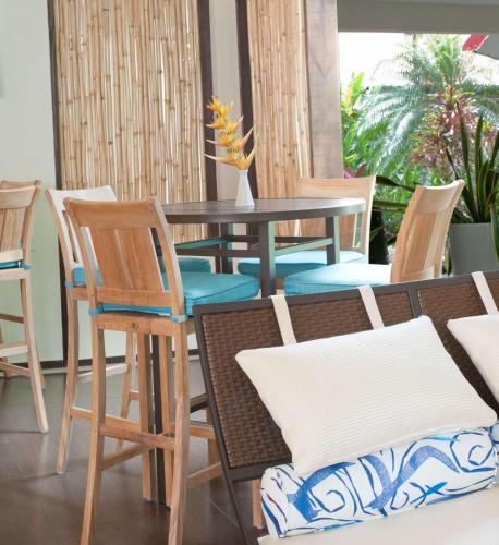 a table and chairs in a room with a table at Radisson Grenada Beach Resort in Grand Anse
