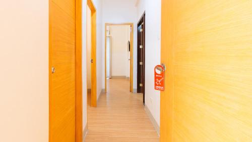 a corridor of an office with a door and a hallway at RedDoorz Plus at Alpina Heights Paranaque in Manila