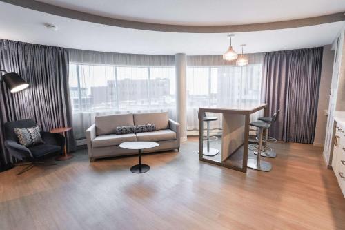a living room with a couch and a table at Radisson Plaza Hotel at Kalamazoo Center in Kalamazoo