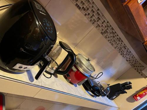 two pots and pans sitting on a kitchen counter at Gamaleo Apartment Namulanda in Namulanda
