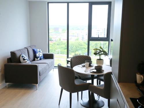 a living room with a couch and a table and chairs at Regent Road - 9th Floor, Pets Allowed, 24hr Shop - Pass the Keys in Manchester