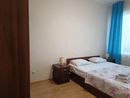 a bedroom with a bed and a dresser and a window at Apartments "Domovik" Івана Парканія 2а кв 19 in Mukacheve