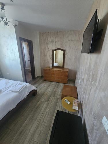 a hotel room with a bed and a mirror at The Bridge House in Balş