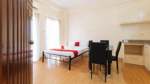 a room with a bed in the middle of a room at RedDoorz Plus at Alpina Heights Paranaque in Manila