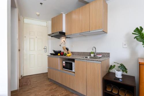 a kitchen with a sink and a counter top at 617A Condotel Near Airport &Mall with Pool,Gym,Netflix in Mactan Cebu International