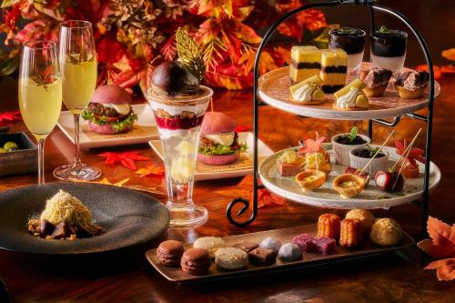 a table with plates of food and glasses of champagne at Shinagawa Prince Hotel in Tokyo