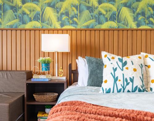 a bedroom with a bed with a table with a lamp at 617A Condotel Near Airport &Mall with Pool,Gym,Netflix in Mactan Cebu International