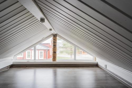 an empty room with a large window with blinds at Guestly Homes - 1BR Countryside Cabin with Sauna in Piteå