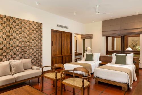 a living room with two beds and a couch at Jetwing Lagoon Wellness, A Luxury Reserve - Adults Only in Negombo