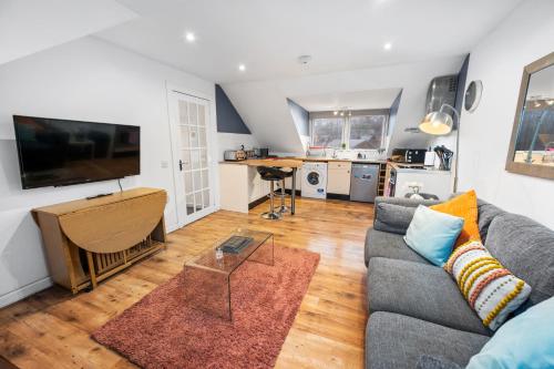 a living room with a couch and a table at Beautiful 2BR Apartment with McCaigs Tower views in Oban