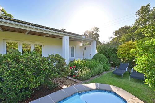 a house with a swimming pool in the yard at Fransvliet Guest House in Franschhoek