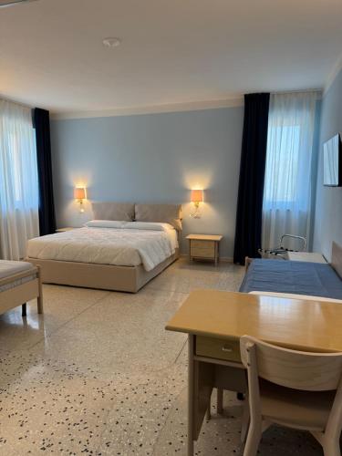 a bedroom with a bed and a table in it at Albergo La Padana in Montebello Vicentino