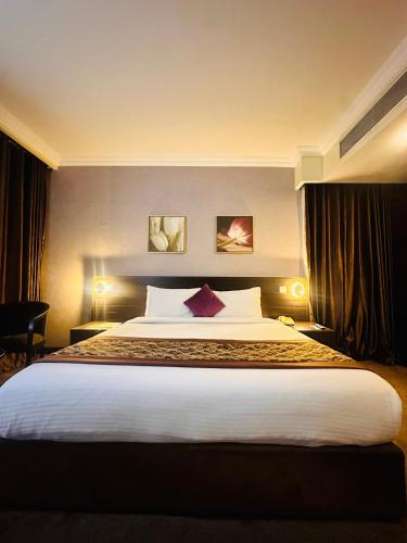 a bedroom with a large bed in a hotel room at Golden Tulip Ibadan in Ibadan