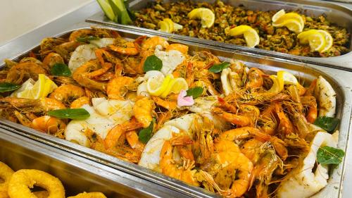 two trays of food with shrimp and other foods at Queen Nelly in Primorsko