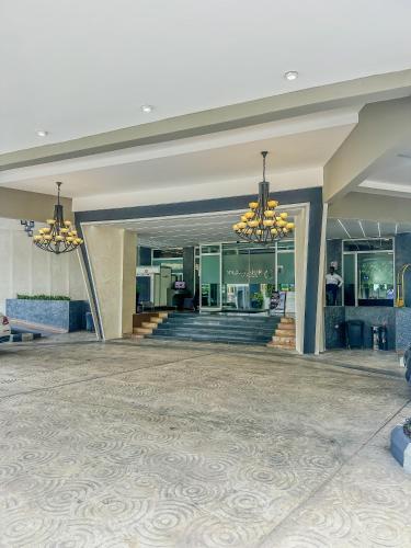 a lobby of a building with two chandeliers at Golden Tulip Ibadan in Ibadan