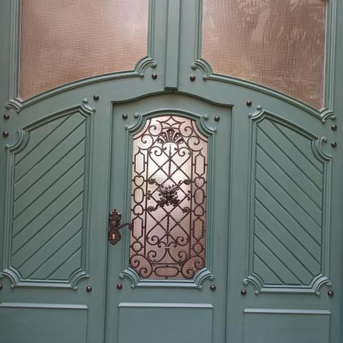 an ornate door with a metal door knocker on it at Art & Craft Apartment in Kecskemét