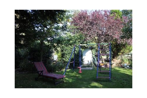 a playground with a bench and a swing at Haus Dreeßen in Buchholz
