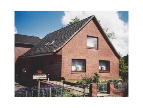 a large brick house with a black roof at Haus Dreeßen in Buchholz