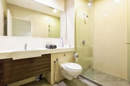 a bathroom with a toilet and a sink and a shower at 118 Island Plaza Penang in Tanjong Tokong