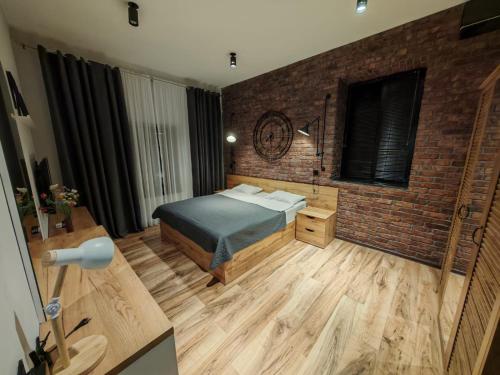 a bedroom with a bed and a brick wall at Sunnyside Bilgah villa 2 in Baku