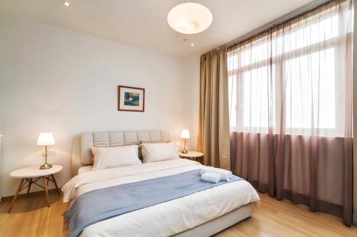 a bedroom with a bed and a large window at 118 Island Plaza Penang in Tanjong Tokong