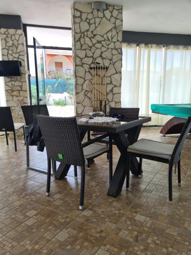 a dining room with a ping pong table and chairs at Villa Joel in Fontane Bianche