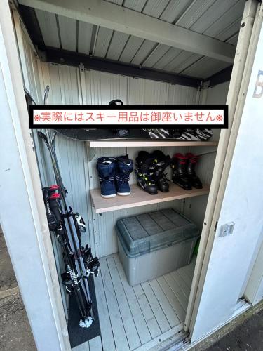a smallshed with a bunch of ski equipment in it at Learch Asahikawa in Asahikawa