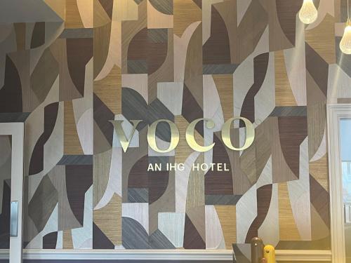 a room with a wall with a yoga sign on it at voco The Clifton Folkestone by IHG in Folkestone