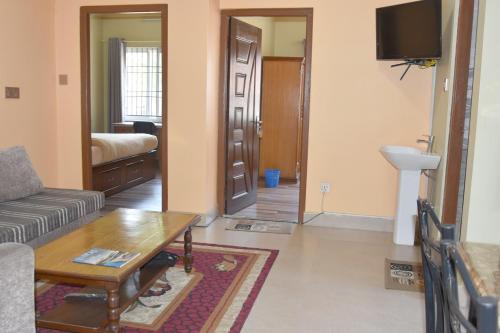 a living room with a couch and a table at Shine Homestay Famille Francophone - Shine Home and Apartment in Kathmandu
