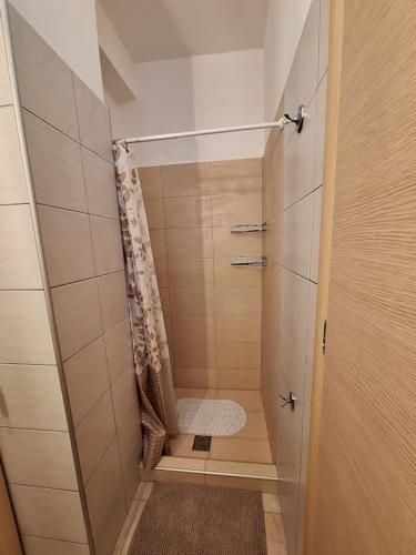 a bathroom with a shower with a bench in it at D and D Home Alonissos in Alonnisos
