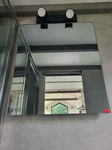 a mirror on the side of a building at Bigge Elements Tinyhaus 5 "Wasser" in Olpe