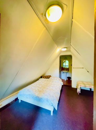 a bedroom with a bed in a small room at King Fern Cottage in Nuwara Eliya