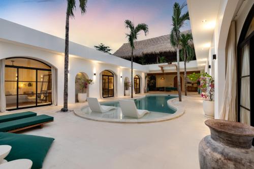 een villa met zwembad en palmbomen bij D'Palm Boutique Hotel - Uluwatu by Yolla Hospitality in Uluwatu