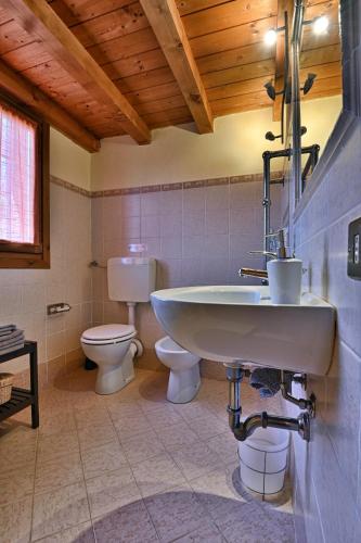a bathroom with a sink and a toilet at Piccolo Rustico, Casaliva - Theater Home in Gargnano