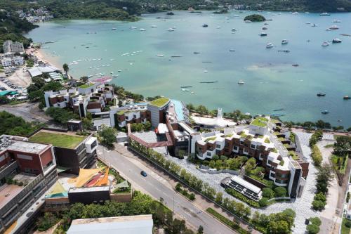 an aerial view of a city with a body of water at WM Hotel Hong Kong, Vignette Collection in Hong Kong