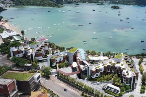an aerial view of a city with a body of water at WM Hotel Hong Kong, Vignette Collection in Hong Kong