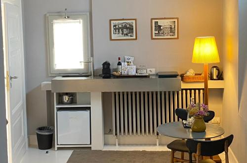 a living room with a table and a radiator at Riva Lofts Florence in Florence