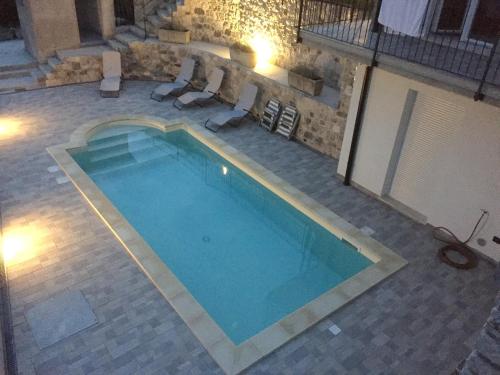 an overhead view of a swimming pool at night at Villa Ada - Theater Home in Tignale