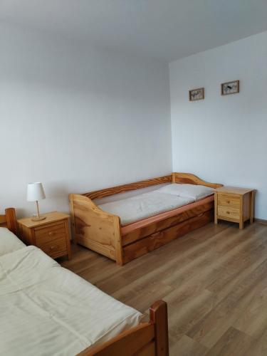 a bedroom with two beds and two night stands at Turistická ubytovňa Hornád in Spišské Tomášovce