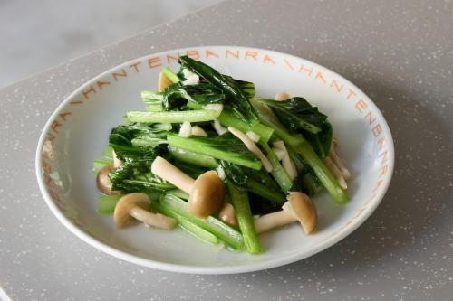 a white plate of food with greens and noodles at SHORTsuido in Tokyo