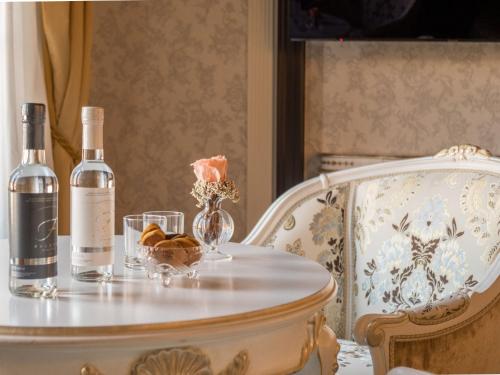 a table with two bottles of wine and flowers on it at EGO' Boutique Hotel - The Silk Road in Venice